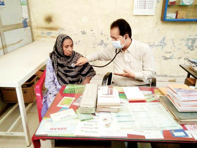 A Deonar resident receives treatment for respiratory complaints at a local trust-run medical camp