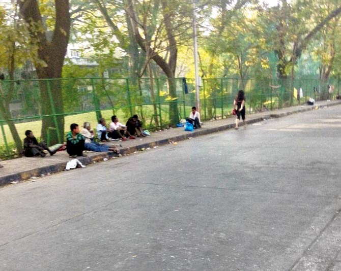 Addicts line up on the pavement adjoining Willingdon club, near the rehab centre in Tardeo, for a free meal