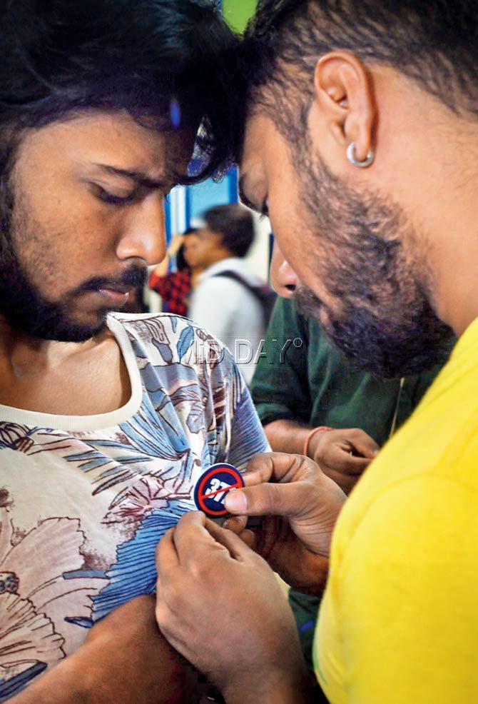 Badges condemning Section 377 being distributed
