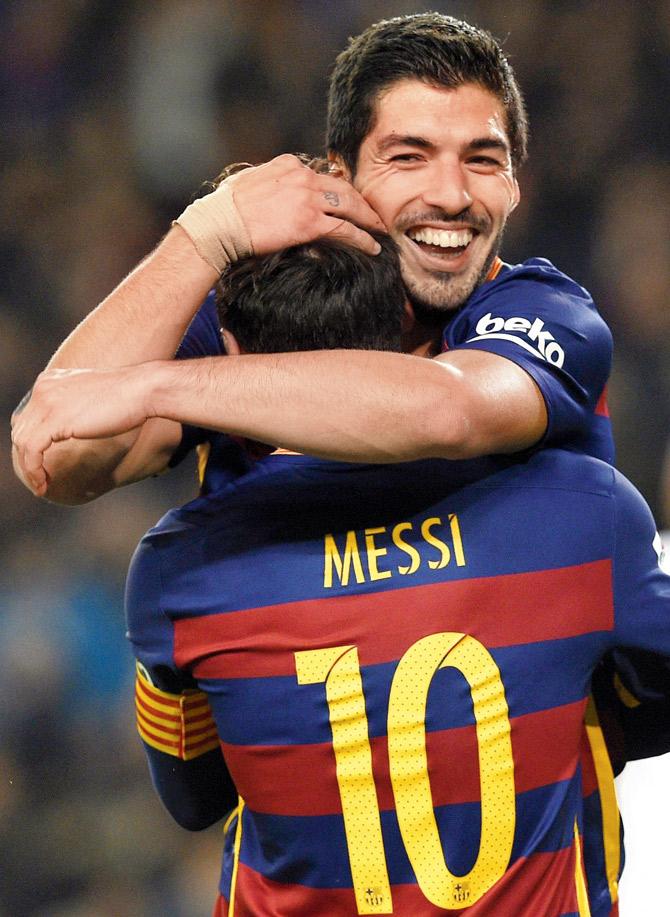 Luis Suarez celebrates a goal with Barca teammate Lionel Messi in a Copa del Rey tie against Valencia on Wednesday. Barca won 7-0