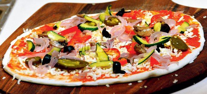 Make it yourself Veg Pizza included delish toppings of onion, jalapeno and veggies, held together by Mama’s sauce