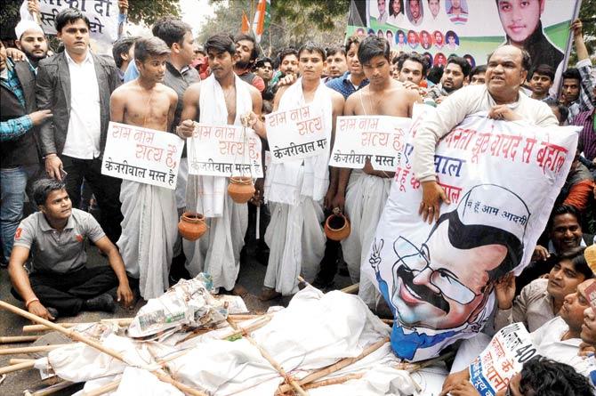 Youth Congress leaders hold a mock funeral march on completion of one year by the AAP in New Delhi on Saturday. Pic/PTI