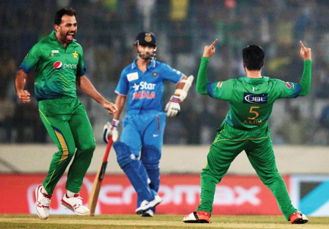 OPENING BLOW: Pakistani pacer Mohammad Amir (right) celebrates with Wahab Riaz after dismissing India opener Rohit Sharma for a duck as non-striker Ajinkya Rahane looks on. Pic: AP/PTI