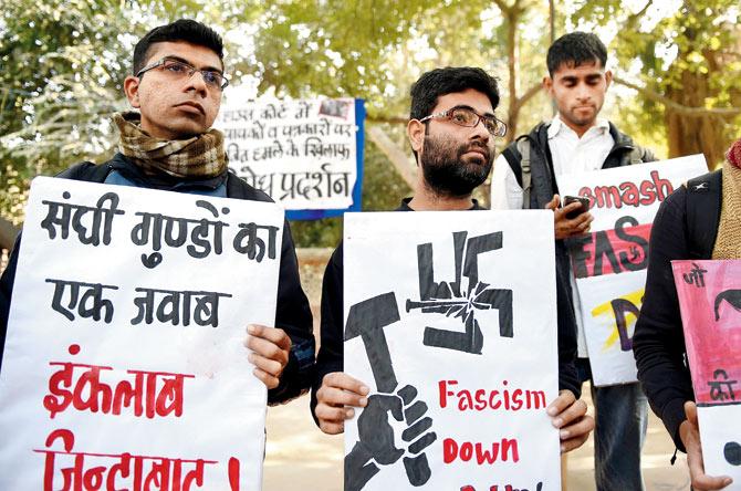 Student activists hold placards against the February 15 attack on JNU students and teachers at Patiala House court. PIC/PTI