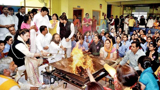 Sri Sri Ravi Shankar performs a hawan along with the students of a school that was torched during the Jat agitation, in Rohtak on Saturday. Pic/PTI