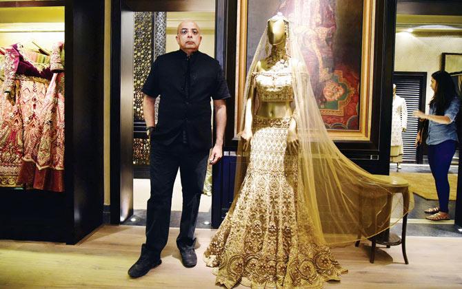 Tahiliani stands rather sternly with one of his prized pieces