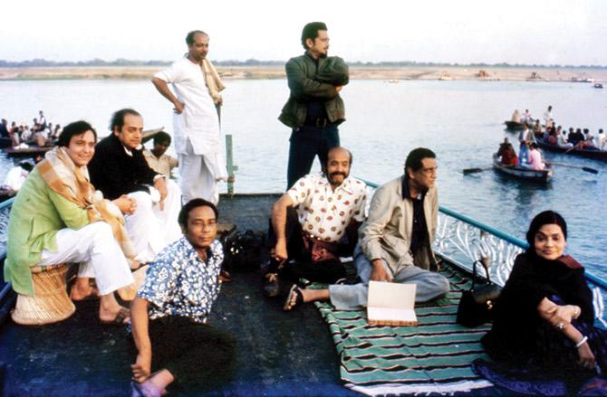 Soumitra Chatterjee (seated, in green) and Utpal Dutt (seated, in black) with Ray (seated, looking out) during a shoot in Varanasi. His wife Bijoya Ray is in the foreground 