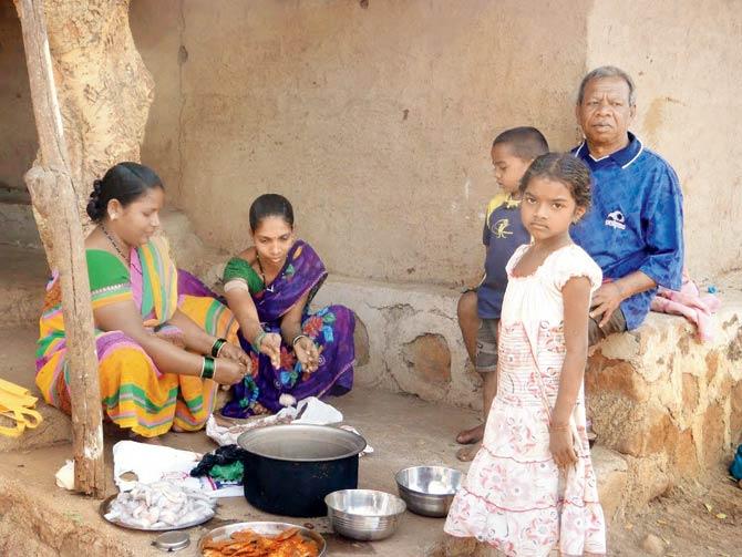 A tribal family prepares lunch at the Aarey Milk Colony