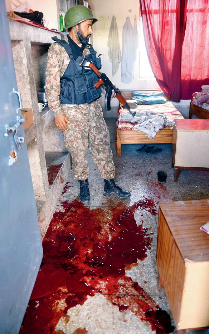 An army soldier searches a room covered in blood at Bacha Khan University hostel. FILE PIC