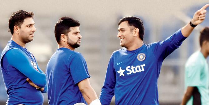 India skipper MS Dhoni (right), Yuvraj Singh (left) and Suresh Raina share a light moment during a practice session on the eve of the T20 international match against Sri Lanka in Pune yesterday. PIC/AFP