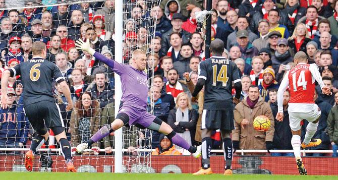 70th minute: Arsenal’s Theo Walcott beats Leicester City goalkeeper  Kasper Schmeichel (in purple) from close range to make it 1-1