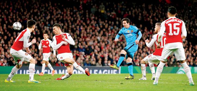 shooting star: Barcelona’s Argentine striker Lionel Messi third from left shoots past Arsenal’s French defender Laurent Koscielny second from left during their UEFA Champions League pre-quarter-final first leg match at the Emirates Stadium in London on Tuesday. Messi scored both goals as Barcelona won 2-0. Pic/AFP