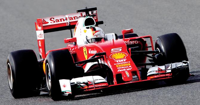 reds hot! Ferrari’s Sebastian Vettel speeds across the Circuit de Catalunya in Spain on Day One of Formula One testing yesterday. pic/AFP 