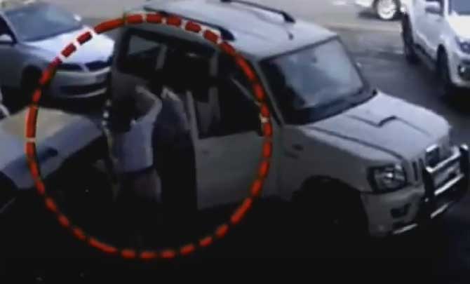 Video grab shows the man assaulting the woman traffic cop