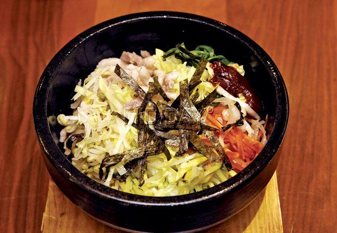 Traditionally,  Chef James Biaka  would break a raw egg  on the the Bibimbap. But  eaters in Mumbai prefer it cooked 
