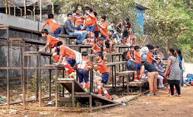 Kids participating in the ongoing MSSA inter-school U-10 football tournament, climb a broken stand at the Goan Sports Association Ground in Cross Maidan yesterday