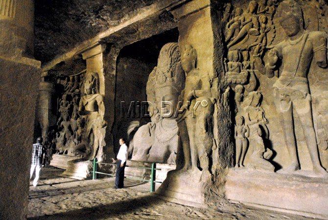 Visitors by the statue of the Hindu deity Sadashiva or eternal Shiva at Elephanta caves. Pic/Pradeep Dhivar