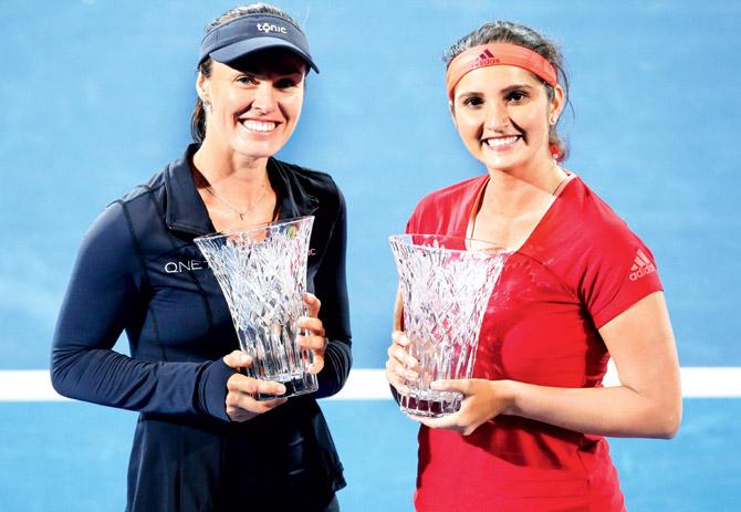 Sania Mirza (right) and Martina Hingis  celebrate winning the Sydney International title yesterday. Pic/Getty Images