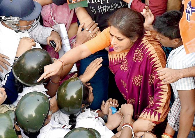 BJP Mohila Morcha leader Rupa Ganguly exchanges heated words with the police in Kolkata on Saturday. PIC/PTI
