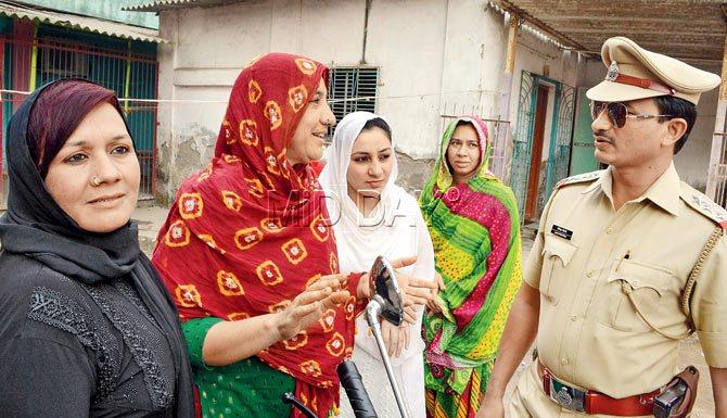 Assistant police inspector Mangesh Borse of Shanti Nagar police station interacts with the members of the Irani community