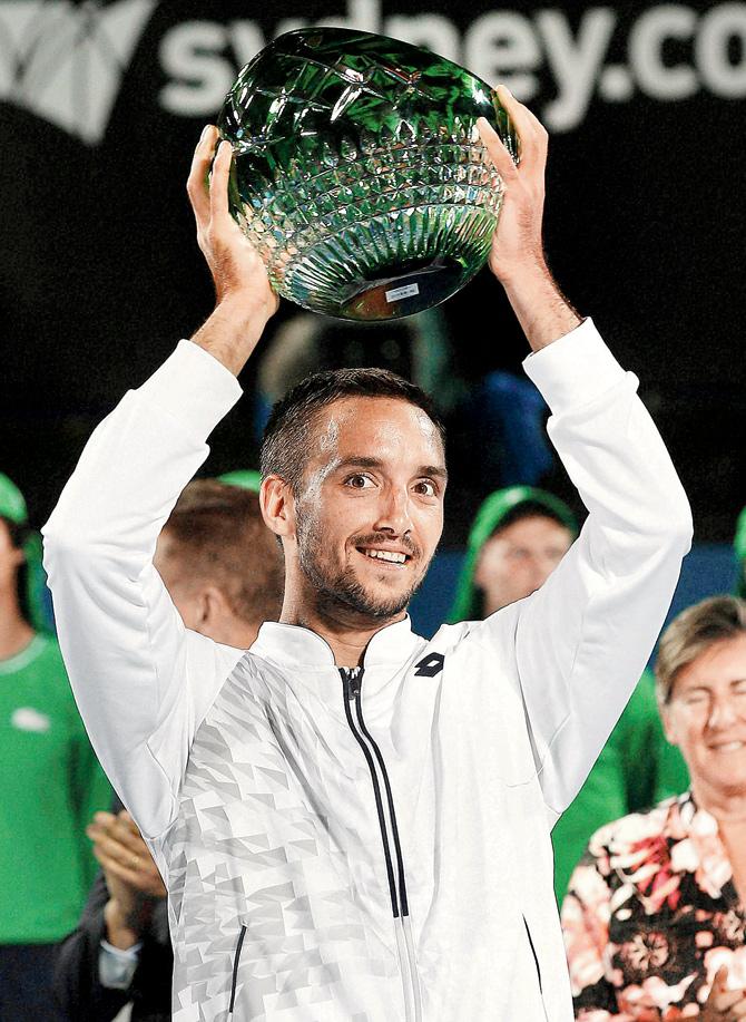 Serbia’s Viktor Troicki poses with the winners trophy in Sydney  on Saturday. PIC/AFP