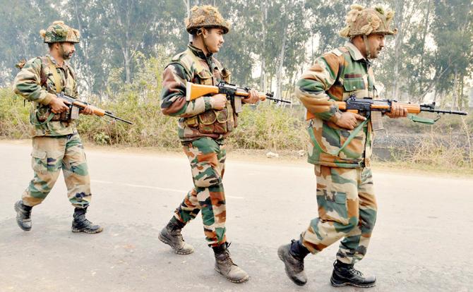 Soldiers patrol  the perimeter of the airforce base in Pathankot on January 4.  File Pics/PTI