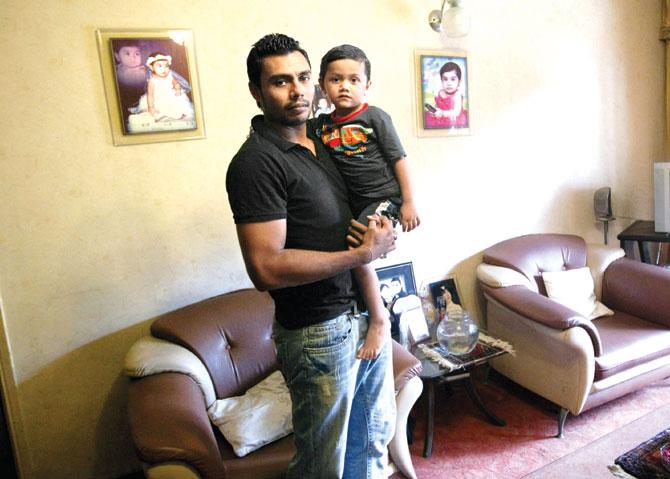 Former Pakistan spinner Danish Kaneria with his son at his Karachi residence in 2011. Pic/AFP