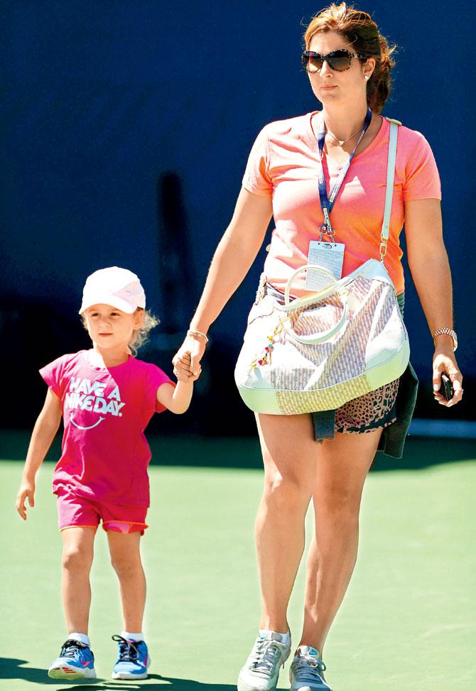 Mirka Federer with one of her children during the 2013 US Open in New York. Pic/Getty Images