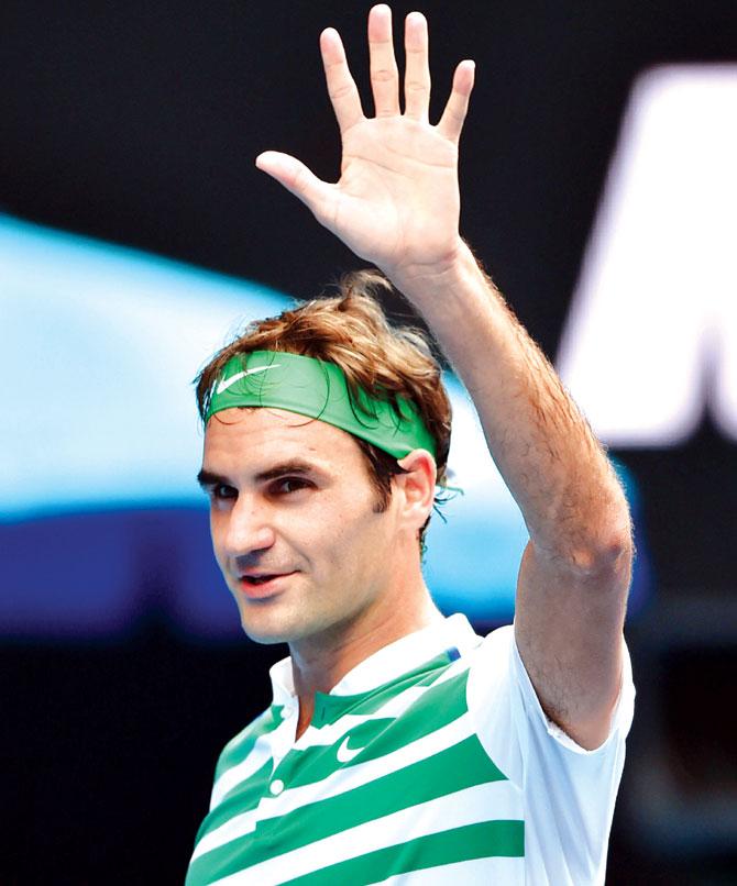 Roger Federer waves to the crowd after his win over Alexandr Dolgopolov at the Australian Open yesterday