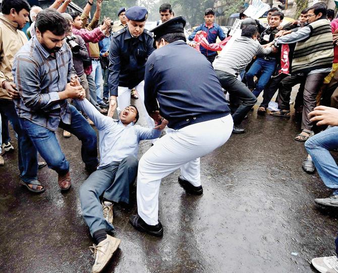 Police detain DSO (students wing of SUCI) activists for holding a protest against the HRDS Ministry in front of Governor House in Kolkata yesterday. Pic/Pti