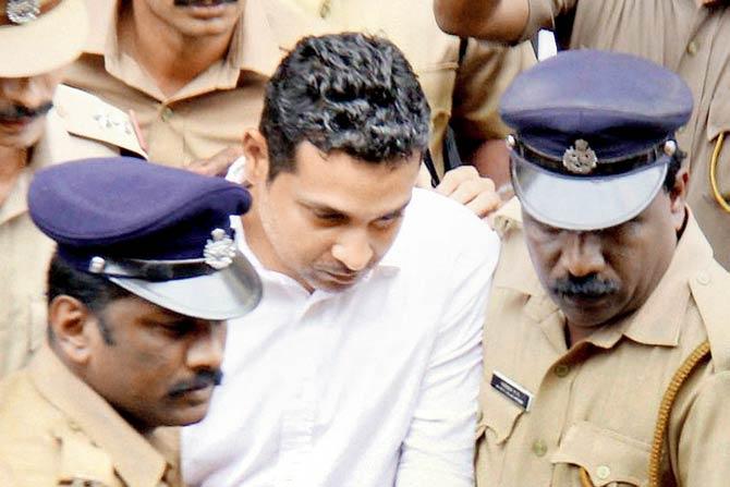 Mohammad Nisham being taken to court yesterday. Pics/PTI 
