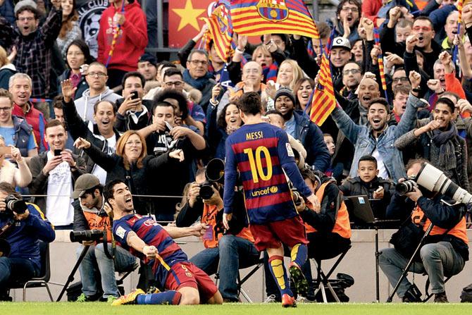 Luis Suarez (left) celebrates with Lionel Messi after scoring a goal. Pic/AFP 