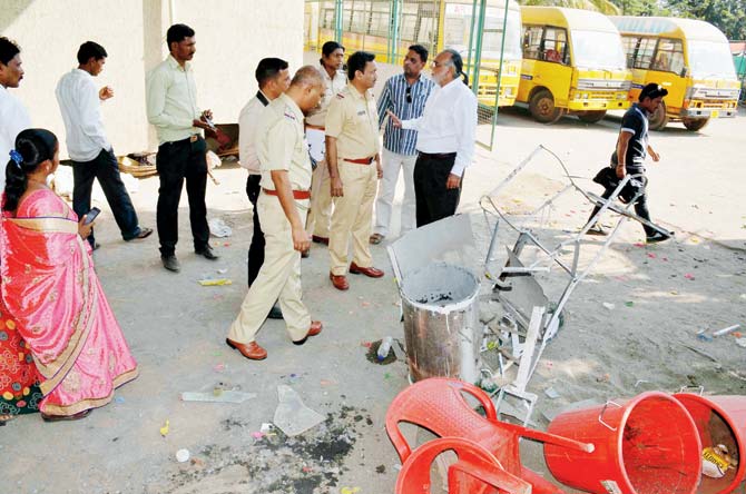 Cops inspect the site of the blast