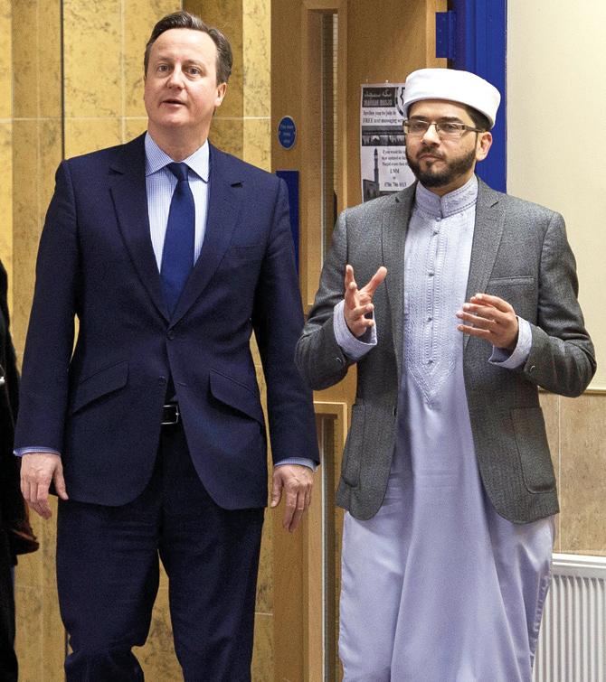 British Prime Minister David Cameron talks with Imam Qari Asim as he visits Makkah Masjid Mosque in Leeds. Pic/AFP