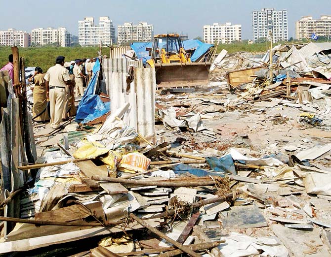 Cops stand guard as civic officials demolish illegal structures