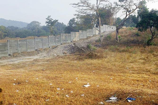 The developer has built a wall blocks access to both wildlife and local tribals who have to walk an extra kilometre around the encroached area