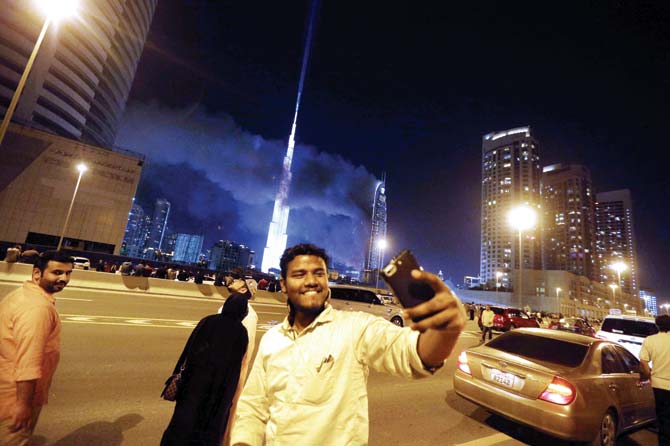 A man takes a selfie as flames rip through the 63-storey hotel