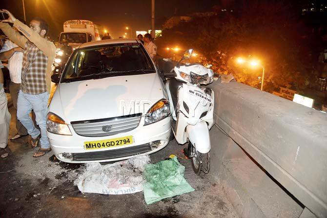 Anwar Atiullah Shaikh, who was riding his Honda Activa, was hit and pushed to the wall of the flyover by a speeding car. Pic/Atul Kamble