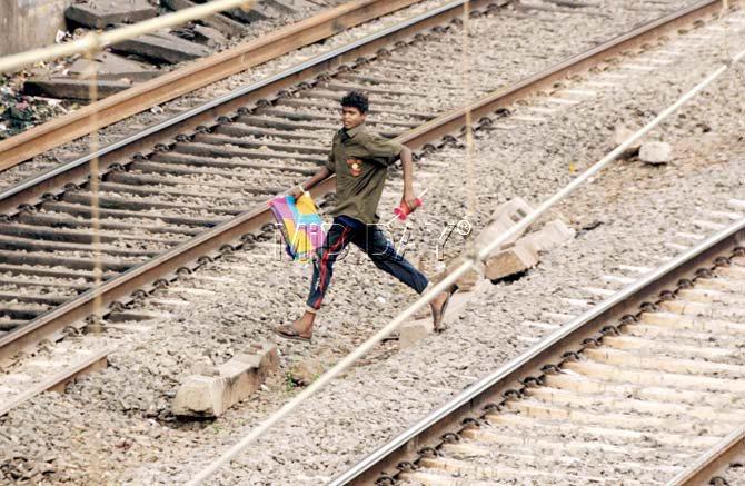 The teen’s joy knows no bounds as he sprints across the tracks with the captured booty in his hands