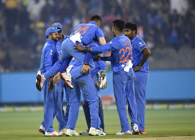 Team India celebrates the fall of an Australian wicket