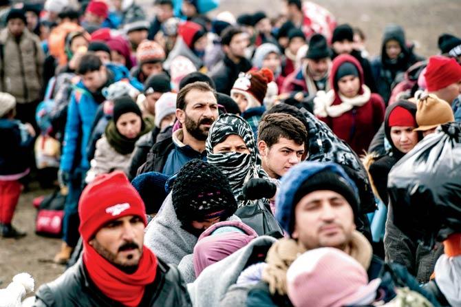 Migrants and refugees wait for security check after crossing the Macedonian border into Serbia. Pic/AFP