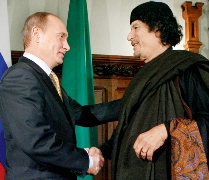 File pic of Russian PM Vladimir Putin with Muammar Gaddafi in Moscow. Pic/AFP