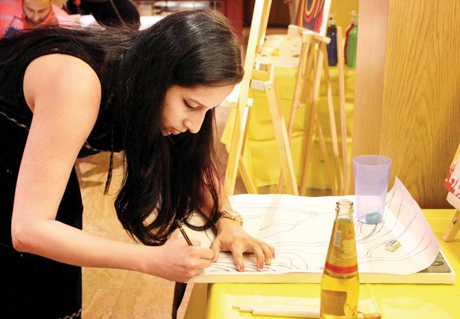 A participant working on her painting at an earlier Paintstorm session