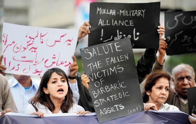 Pakistani activists shout slogans against the attack. Pic/AFP