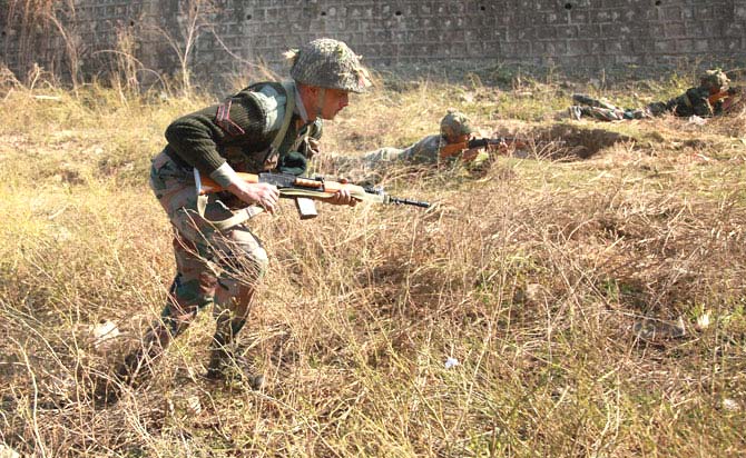 Army soldiers conduct a search operation in a forest area outside the Air Force Base in Pathankot. Pic/PTI
