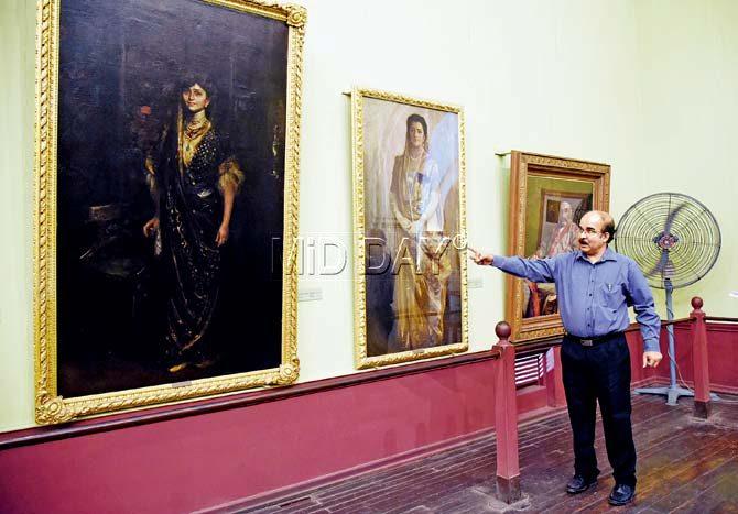 Sabyasachi Mukherjee points to portraits of the wives of Ratan Tata and Dorab Tata respectively