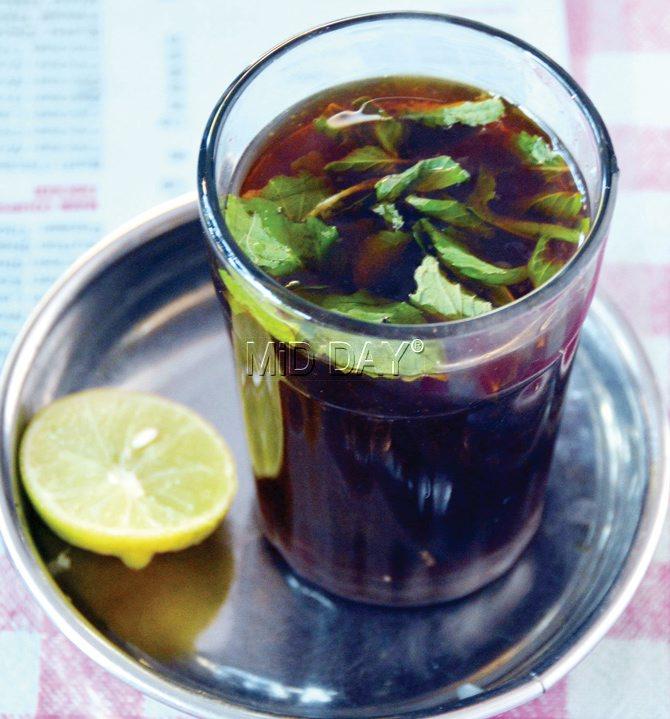 Suleimani chai is served with lemon and mint