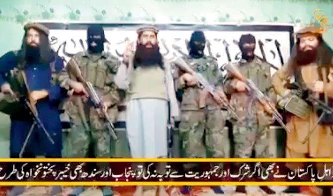A still from a video released by Taliban yesterday showing their leader Khalifa Umar Mansoor (centre) with militants. Pic/AFP