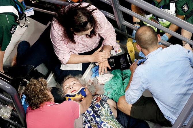Medical personnel attend to a spectator during a break in play at the Rod Laver Arena yesterday