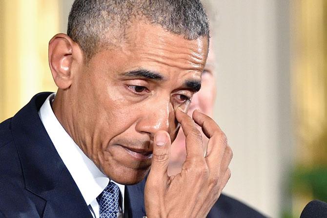 US President Barack Obama, wiping away tears as he promised to be resolute in tackling gun violence. Pic/AFP